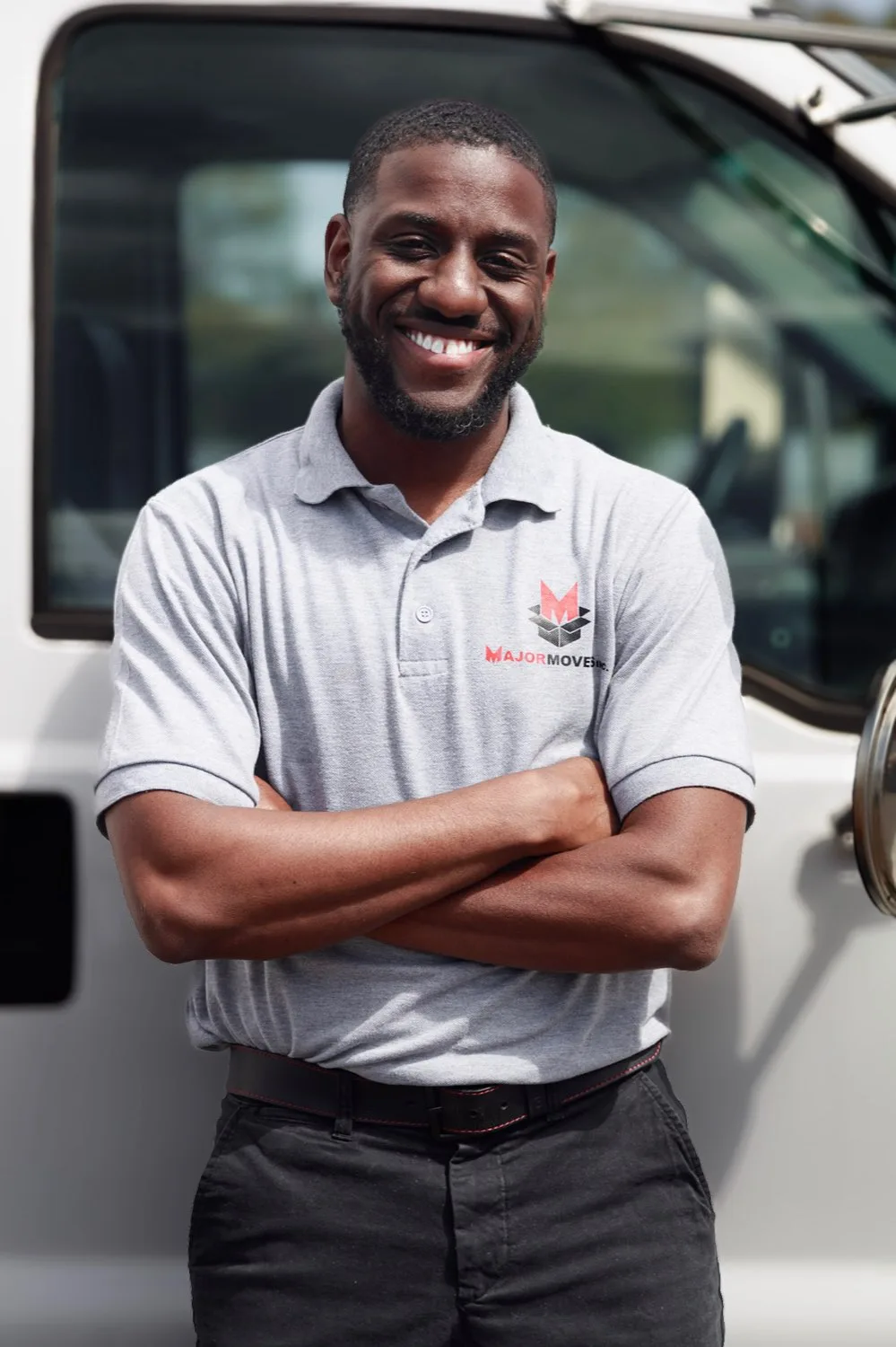 A Major Movers team member standing beside a white truck