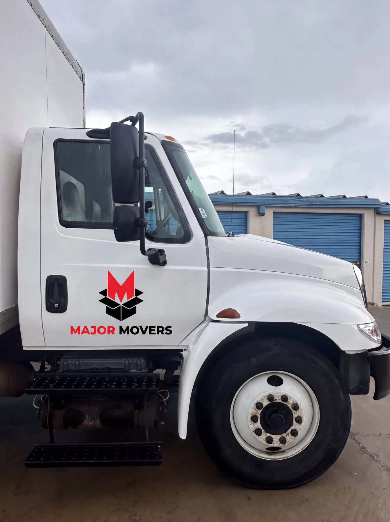 Major Movers truck parked beside storage units
